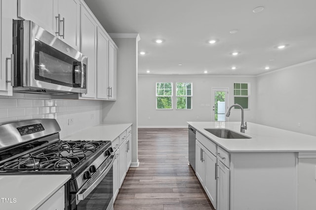 223 Aster Bloom Ln, Raleigh, NC 27610 - kitchen featuring stainless steel appliances, ornamental molding, dark wood-type flooring, light countertops, and recessed lighting