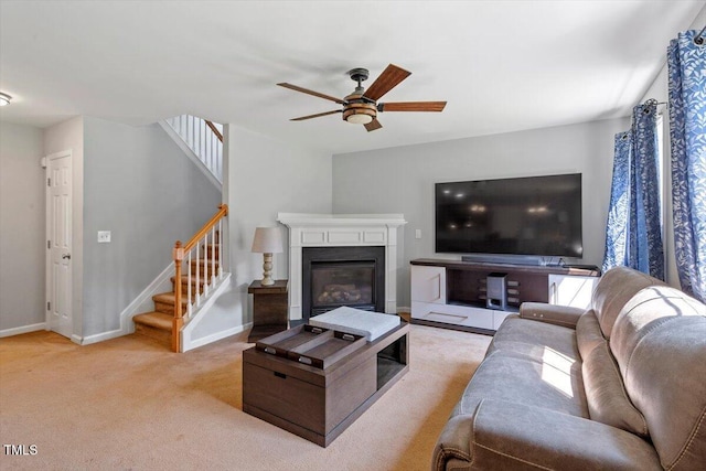 20 Allyson Ct, Youngsville, NC 27596 - living room with stairs, a ceiling fan, light carpet, and a glass covered fireplace