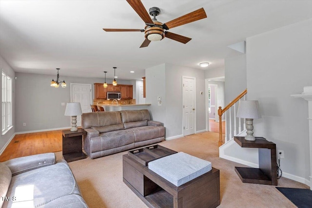 20 Allyson Ct, Youngsville, NC 27596 - living area featuring ceiling fan, a chandelier, stairs, and light colored carpet