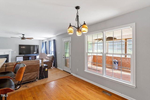20 Allyson Ct, Youngsville, NC 27596 - living room featuring light wood-style flooring, a ceiling fan, and a fireplace