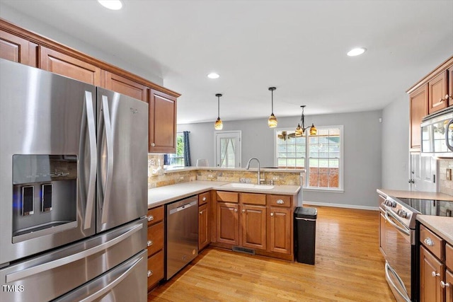 20 Allyson Ct, Youngsville, NC 27596 - kitchen featuring appliances with stainless steel finishes, a peninsula, light countertops, tasteful backsplash, and recessed lighting