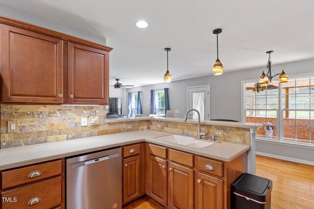 20 Allyson Ct, Youngsville, NC 27596 - kitchen featuring dishwasher, decorative backsplash, a peninsula, brown cabinetry, and recessed lighting
