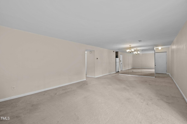 667 Pine Ridge Pl, Raleigh, NC 27609 - unfurnished living room with a chandelier and light colored carpet