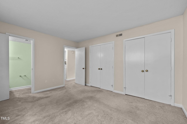 667 Pine Ridge Pl, Raleigh, NC 27609 - unfurnished bedroom with multiple closets, carpet floors, and ensuite bath