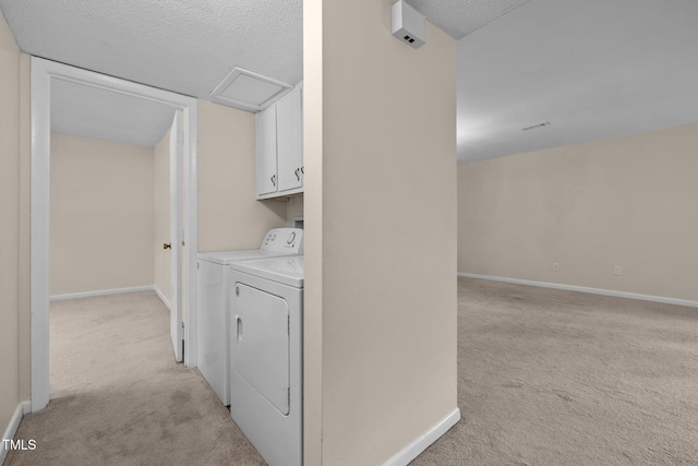 667 Pine Ridge Pl, Raleigh, NC 27609 - washroom featuring cabinet space, light colored carpet, a textured ceiling, attic access, and separate washer and dryer