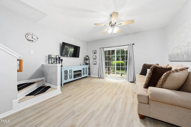 7645 Winners Edge St, Raleigh, NC 27617 - living area featuring wood finished floors, a ceiling fan, and stairway