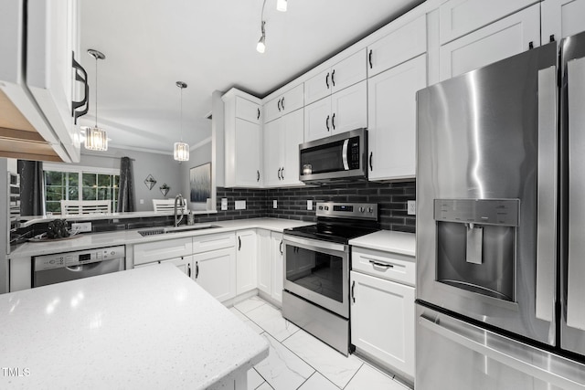 7645 Winners Edge St, Raleigh, NC 27617 - kitchen featuring stainless steel appliances, light marble finish flooring, hanging light fixtures, white cabinets, and crown molding