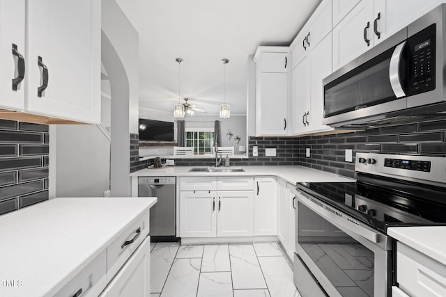 7645 Winners Edge St, Raleigh, NC 27617 - kitchen with appliances with stainless steel finishes, light marble finish floors, light countertops, backsplash, and white cabinetry