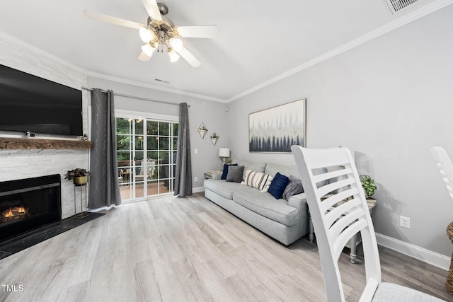 7645 Winners Edge St, Raleigh, NC 27617 - living area featuring ceiling fan, wood finished floors, a fireplace, and crown molding
