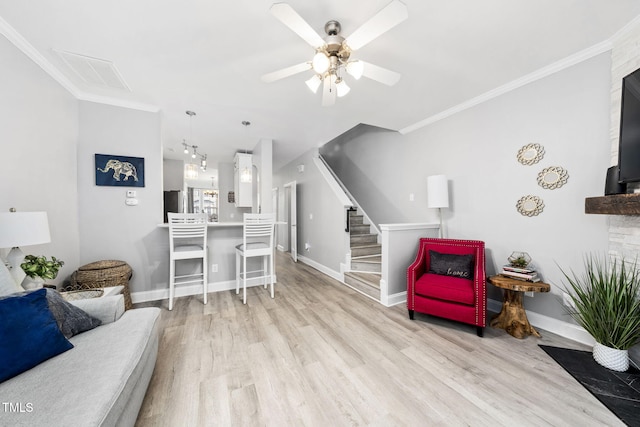 7645 Winners Edge St, Raleigh, NC 27617 - living room with ceiling fan, wood finished floors, stairway, and ornamental molding