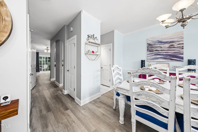 7645 Winners Edge St, Raleigh, NC 27617 - bedroom with wood finished floors, a chandelier, arched walkways, and ornamental molding