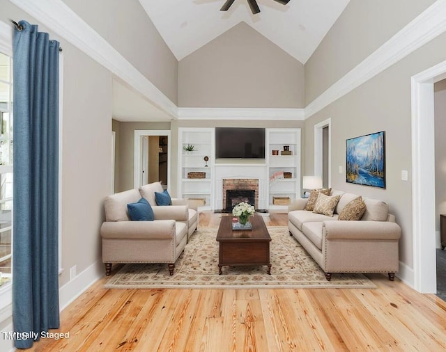 103 N Mckay Ave, Dunn, NC 28334 - living area with high vaulted ceiling, a ceiling fan, built in features, wood finished floors, and a fireplace with flush hearth