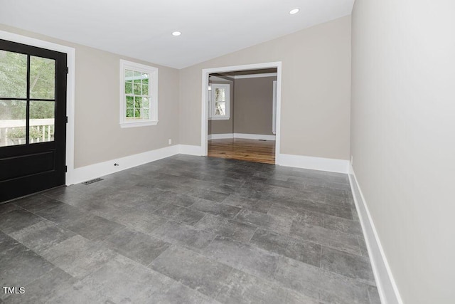 103 N Mckay Ave, Dunn, NC 28334 - spare room featuring vaulted ceiling, stone finish flooring, and recessed lighting