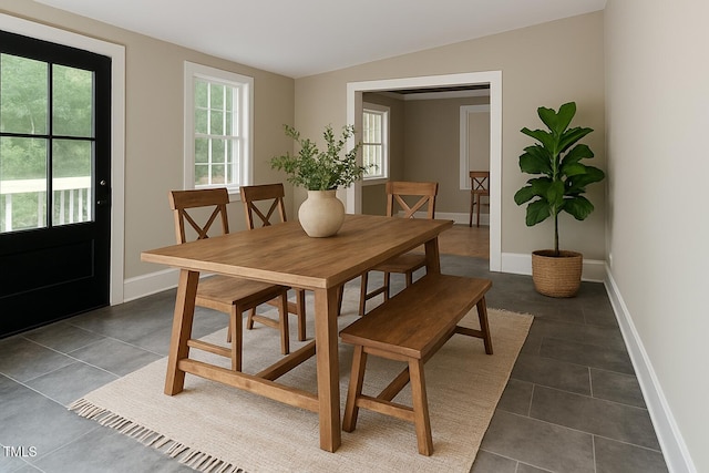 103 N Mckay Ave, Dunn, NC 28334 - dining area featuring dark tile patterned floors and baseboards