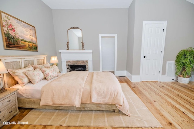 103 N Mckay Ave, Dunn, NC 28334 - bedroom with wood finished floors and a stone fireplace