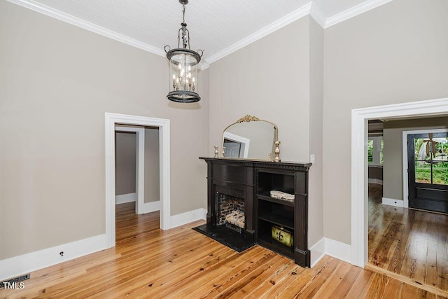 103 N Mckay Ave, Dunn, NC 28334 - dining area featuring a chandelier, crown molding, light wood-style flooring, and a fireplace