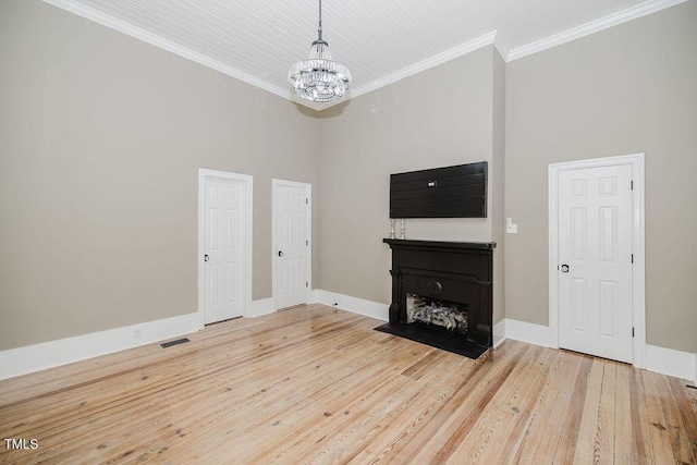 103 N Mckay Ave, Dunn, NC 28334 - unfurnished living room with a chandelier, ornamental molding, wood finished floors, a fireplace, and a high ceiling
