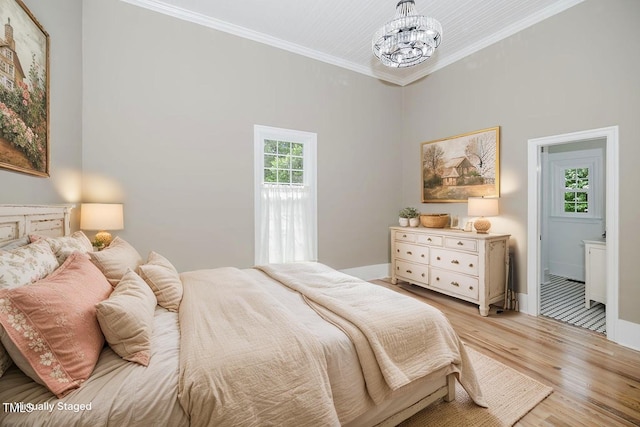 103 N Mckay Ave, Dunn, NC 28334 - bedroom featuring crown molding, a chandelier, and light wood-style floors