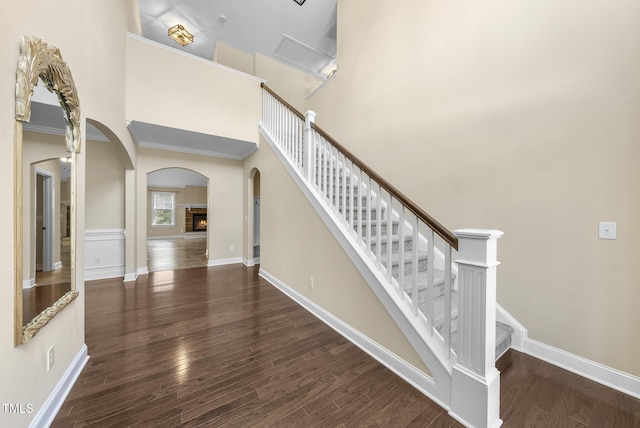 347 Country Mill Way, Fuquay Varina, NC 27526 - stairs featuring arched walkways, wood finished floors, a towering ceiling, and ornamental molding
