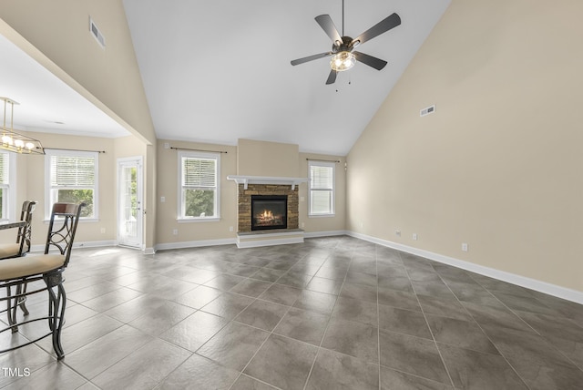 347 Country Mill Way, Fuquay Varina, NC 27526 - unfurnished living room featuring high vaulted ceiling, ceiling fan, dark tile patterned floors, and a stone fireplace