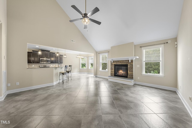 347 Country Mill Way, Fuquay Varina, NC 27526 - unfurnished living room with high vaulted ceiling, a ceiling fan, and a fireplace