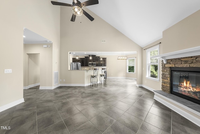 347 Country Mill Way, Fuquay Varina, NC 27526 - living area with high vaulted ceiling, a fireplace, ceiling fan, and a chandelier
