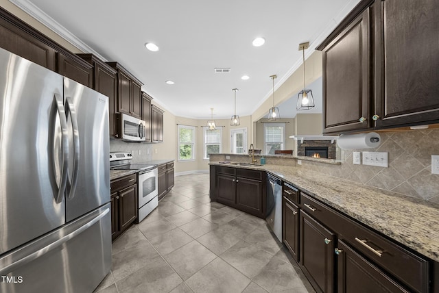 347 Country Mill Way, Fuquay Varina, NC 27526 - kitchen with appliances with stainless steel finishes, dark brown cabinetry, tasteful backsplash, light stone counters, and recessed lighting