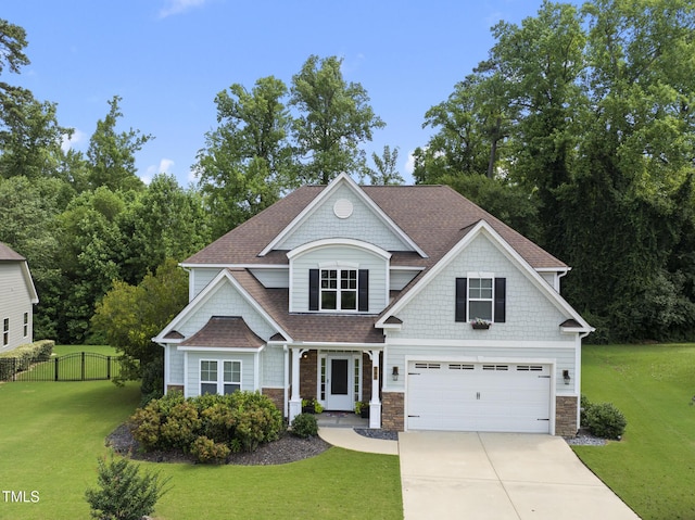 347 Country Mill Way, Fuquay Varina, NC 27526 - view of front of home featuring stone siding, concrete driveway, a garage, and a shingled roof