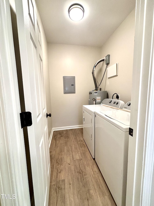6 First St, Franklinton, NC 27525 - laundry area featuring washing machine and dryer, electric panel, light wood-style flooring, and electric water heater