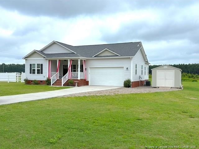 893 Blanchard Rd, Saint Pauls, NC 28384 - ranch-style house featuring an attached garage, covered porch, a storage shed, driveway, and crawl space