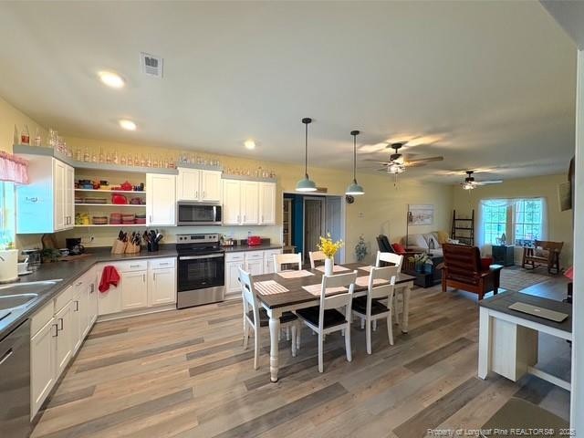 893 Blanchard Rd, Saint Pauls, NC 28384 - kitchen with appliances with stainless steel finishes, dark countertops, open shelves, white cabinets, and recessed lighting