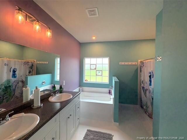 893 Blanchard Rd, Saint Pauls, NC 28384 - full bathroom featuring a bath, double vanity, and a shower with shower curtain