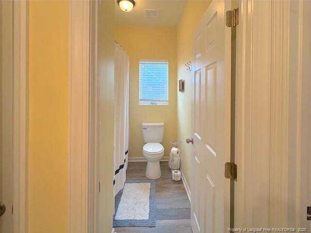 893 Blanchard Rd, Saint Pauls, NC 28384 - bathroom with wood finished floors and a shower with shower curtain