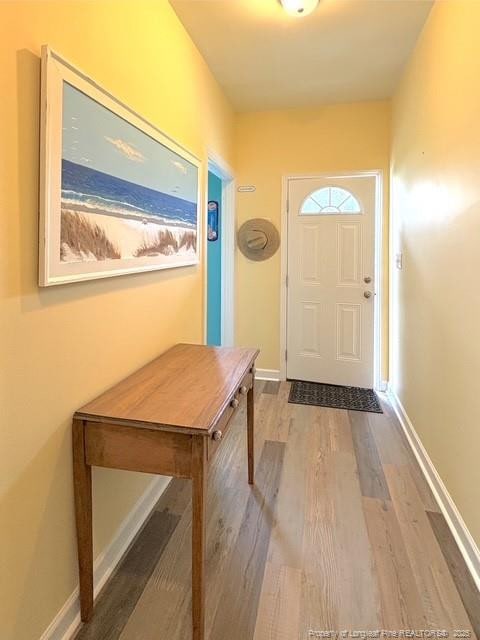 893 Blanchard Rd, Saint Pauls, NC 28384 - doorway to outside featuring wood finished floors and baseboards
