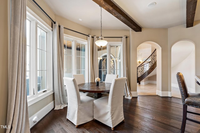 19 San Rimini Way, Durham, NC 27707 - dining area featuring arched walkways, beam ceiling, dark wood-style flooring, and stairway