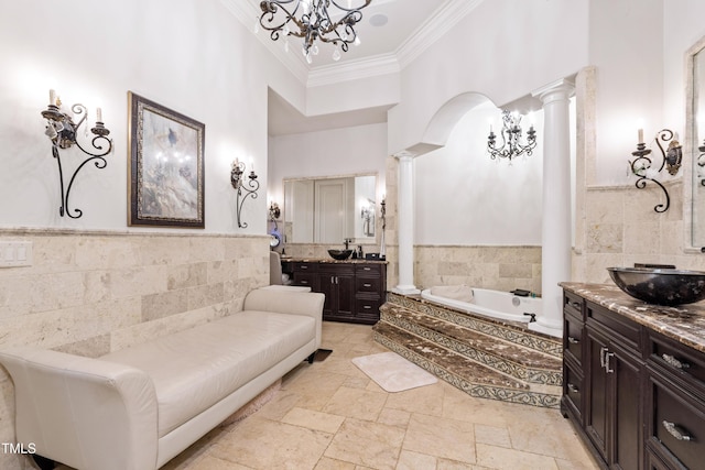 19 San Rimini Way, Durham, NC 27707 - bathroom featuring ornate columns, ornamental molding, tile walls, a bath, and two vanities
