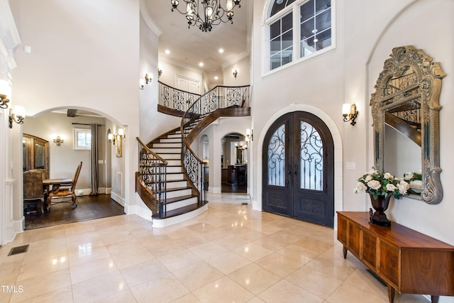 19 San Rimini Way, Durham, NC 27707 - tiled entrance foyer with arched walkways, a towering ceiling, stairs, ornamental molding, and french doors