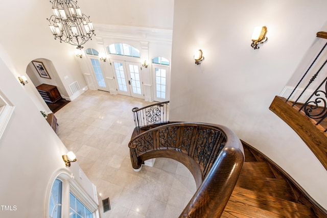 19 San Rimini Way, Durham, NC 27707 - tiled foyer entrance with arched walkways, a chandelier, french doors, and a high ceiling