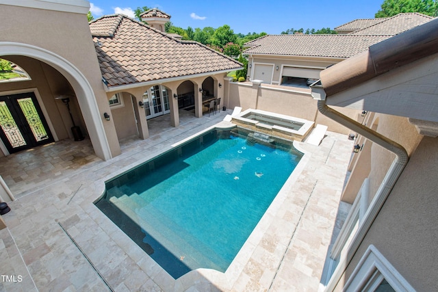19 San Rimini Way, Durham, NC 27707 - view of swimming pool featuring french doors, exterior kitchen, a pool with connected hot tub, and a patio