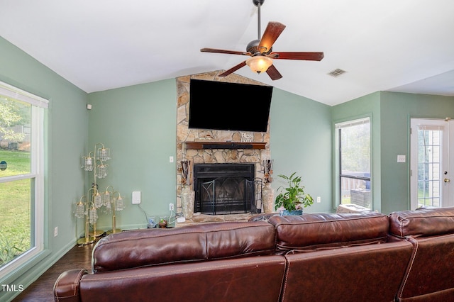 5700 Eagle Pass Cir, Fayetteville, NC 28304 - living room featuring a stone fireplace, vaulted ceiling, a ceiling fan, and wood finished floors