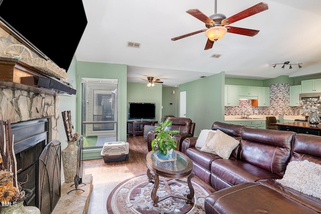 5700 Eagle Pass Cir, Fayetteville, NC 28304 - living area with a ceiling fan, light wood-style floors, and a fireplace