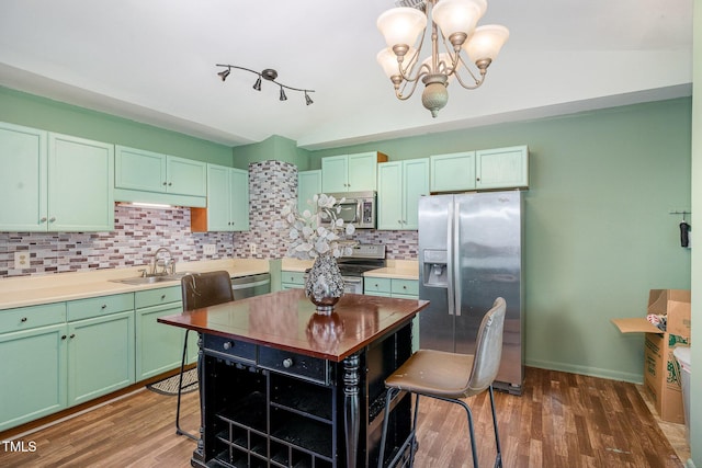 5700 Eagle Pass Cir, Fayetteville, NC 28304 - kitchen featuring appliances with stainless steel finishes, vaulted ceiling, tasteful backsplash, a chandelier, and green cabinetry