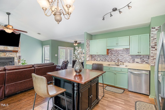 5700 Eagle Pass Cir, Fayetteville, NC 28304 - kitchen with stainless steel appliances, ceiling fan, open floor plan, a breakfast bar, and a stone fireplace