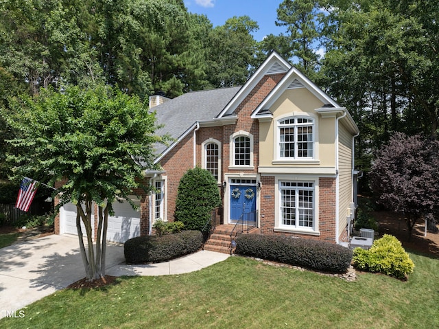 107 Ackworth Ct, Cary, NC 27519 - traditional-style house with brick siding, concrete driveway, a front lawn, a garage, and a chimney