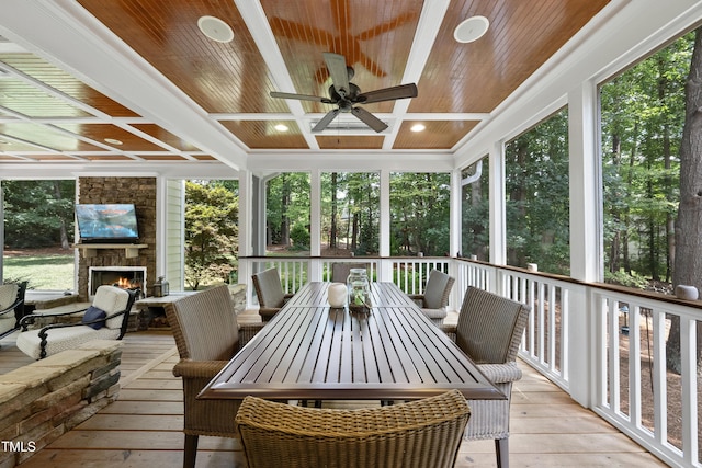 107 Ackworth Ct, Cary, NC 27519 - sunroom with a fireplace, ceiling fan, coffered ceiling, outdoor dining area, and beam ceiling