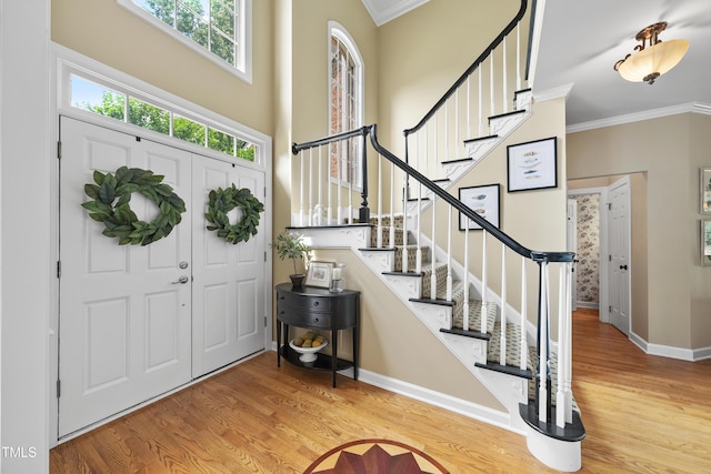 107 Ackworth Ct, Cary, NC 27519 - foyer featuring wood finished floors, ornamental molding, stairway, and a towering ceiling