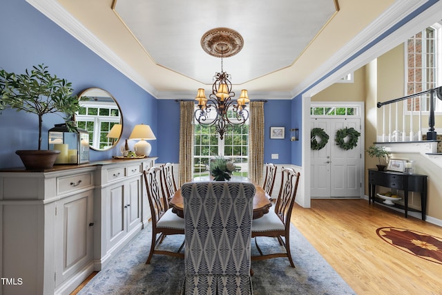 107 Ackworth Ct, Cary, NC 27519 - dining space with a chandelier, plenty of natural light, wood finished floors, crown molding, and a tray ceiling