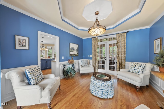 107 Ackworth Ct, Cary, NC 27519 - living room with french doors, a raised ceiling, healthy amount of natural light, ornamental molding, and a decorative wall