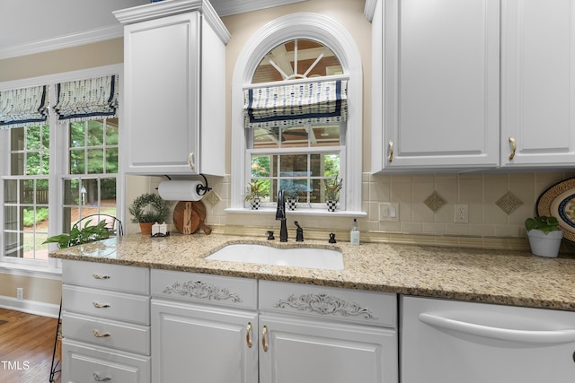 107 Ackworth Ct, Cary, NC 27519 - kitchen featuring dishwasher, white cabinets, ornamental molding, and decorative backsplash