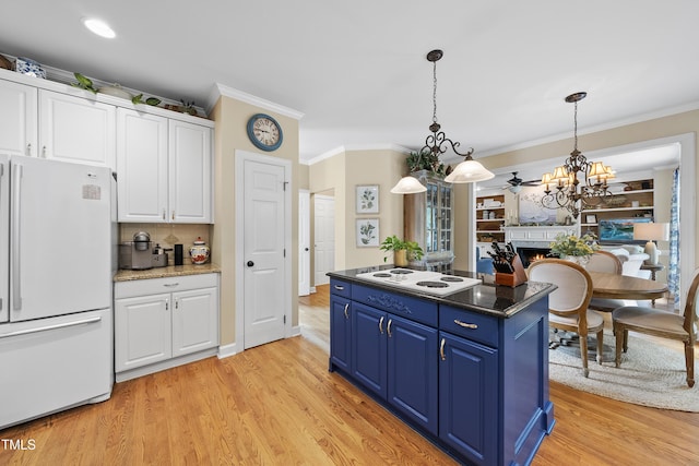 107 Ackworth Ct, Cary, NC 27519 - kitchen featuring white appliances, blue cabinets, white cabinetry, crown molding, and a warm lit fireplace
